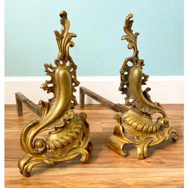 Exquisite pair of andirons with brass Rococo style filigree and cast iron bracket supports. Made in France in the late...
