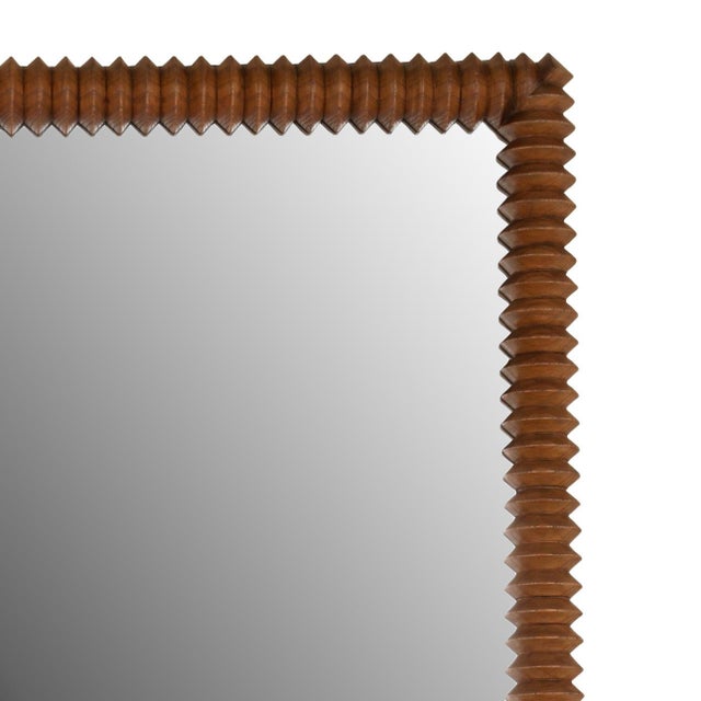 This striking mirror features a richly toned Mindi wood frame with distinctive ribbed carved design that create depth,...