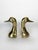 Pair of gilt brass bookends, France, 1970s, depicting stylized duck heads. Each piece has an elegant, sculptural form,...