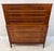 Striking Mid-Century Modern highboy dresser featuring a warm walnut finish, rich wood grain, and beautifully detailed...