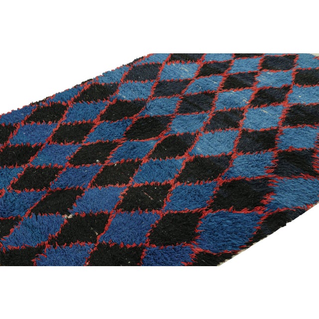 Hand-knotted in wool and originating from Morocco circa 1950-1960, this 5x8 vintage Moroccan rug is an extremely rare...