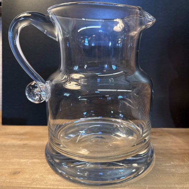 Pretty hand blown glass pitcher. 8” tall x 8” wide I great condition no chips air cracks. Ready to simply look pretty or...