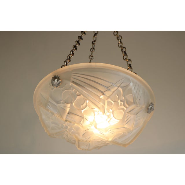 Amazing French Art Deco pendant chandelier by Mouynet (Paris), France, late 1920s. White frosted glass shade with a...