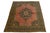 An antique Persian Tabriz rug featuring a terracotta field with a beautifully detailed center medallion and multicolored...