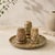 A striking vintage condiment set carved from fossil coral marble, showcasing naturally preserved marine fossils embedded...