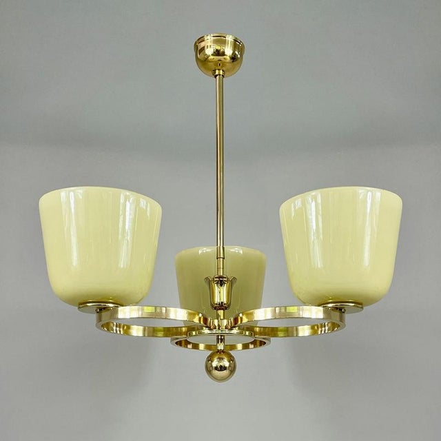 Art deco opaline glass & brass chandelier, germany 1930s this vintage art deco chandelier features three upward-facing,...