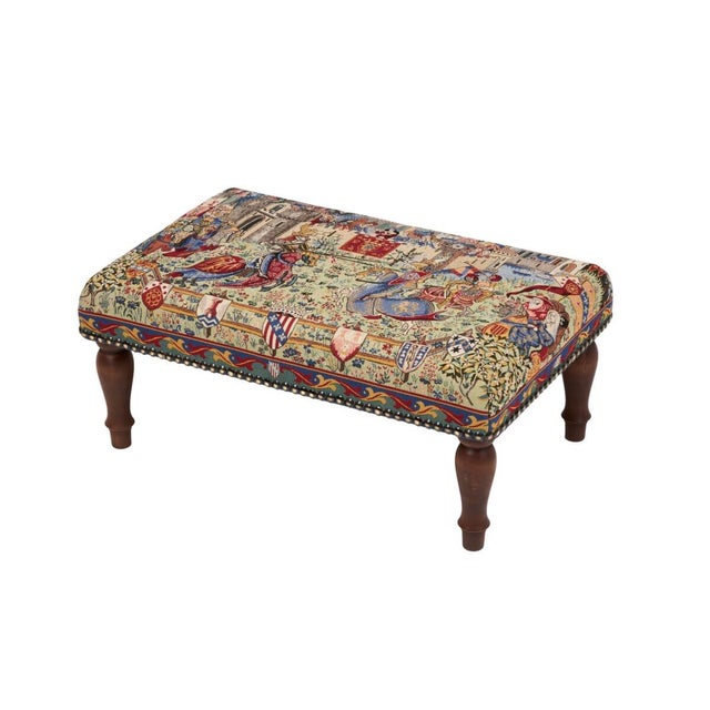 Meticulously handcrafted in the United Kingdom, this upholstered stool boasts classic studding and hand-polished solid...