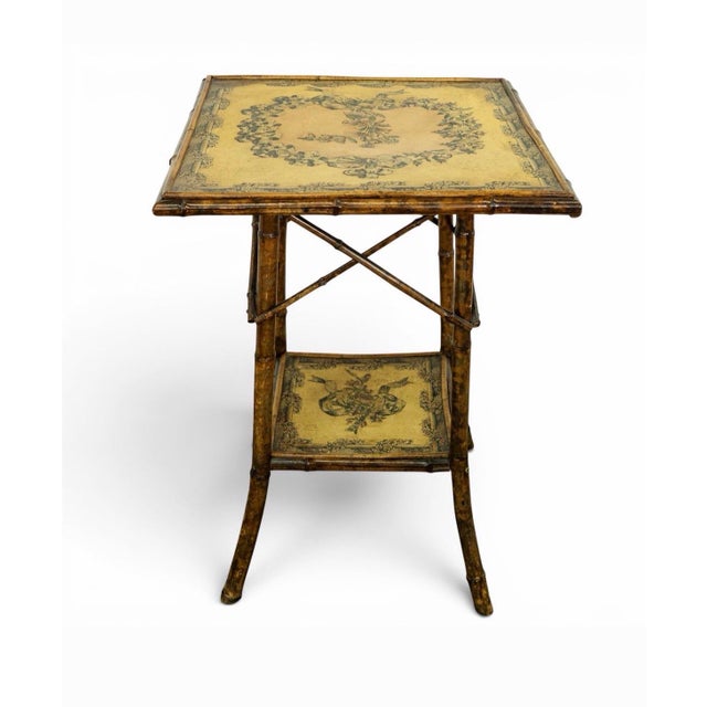 Late 19th century, English two - tier accent table. Constructed with naturally burnt bamboo frame. The top design features...