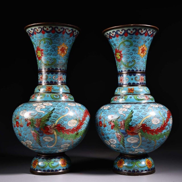 This exquisite pair of cloisonne enamel vases features a classic baluster form with a flared rim and a bulbous body. Each...
