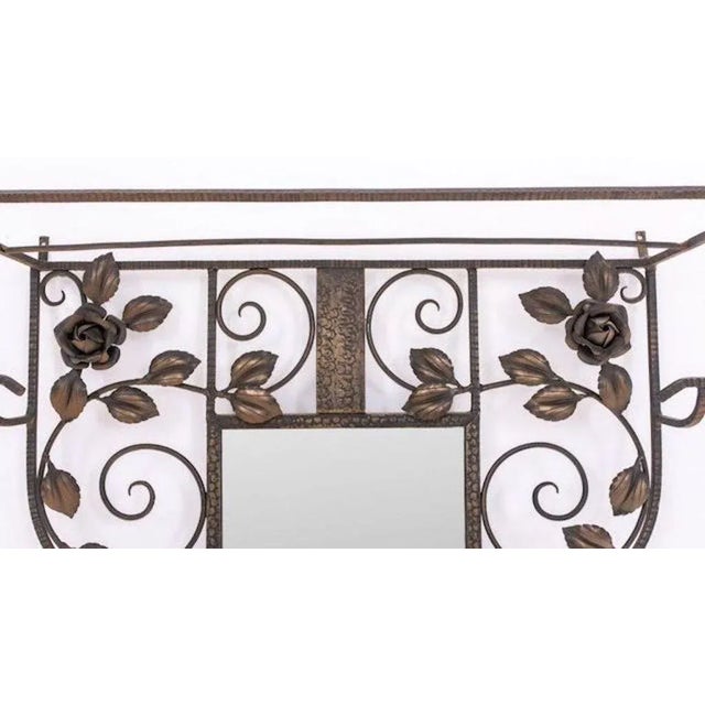 French Art Deco hanging wall coat rack with umbrella rack. Center mirror surrounded by floral roses. Hanged forged wrought...