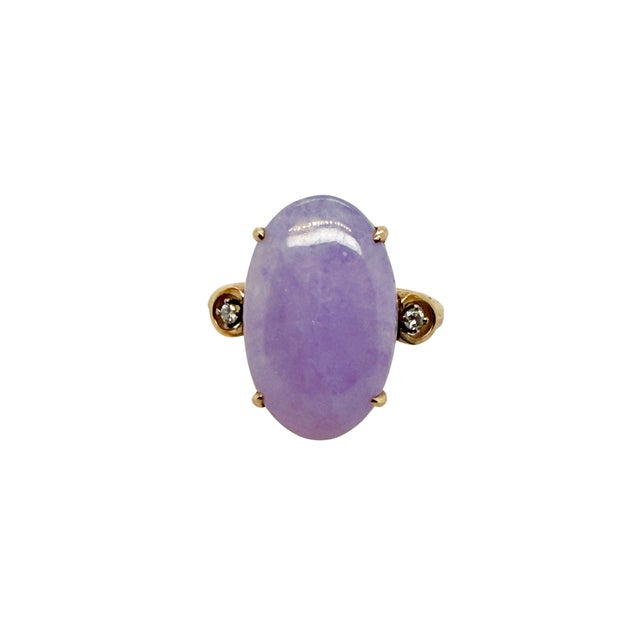 This elegant mid‑century ring features an oval lavender jade cabochon set in warm 14K gold and accented by two diamonds....