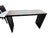 This striking console table features a sleek dark metal frame with decorative brass stud accents and a wood-tone surface...