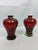 A refined pair of 1970s Murano glass vases, handblown in rich red glass with shimmering goldstone inclusions that catch...