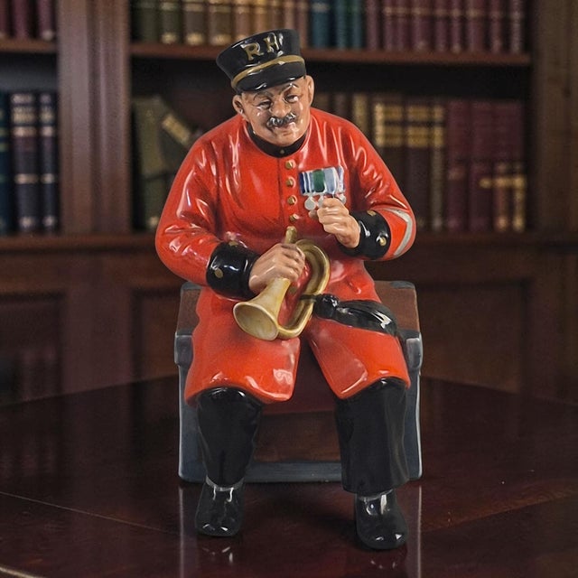 The Royal Doulton Figurine "Past Glory" is a beautifully crafted collectible piece from the Classic Collection. Made of...