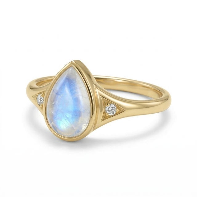 Rainbow Moonstone Pear-Shaped Ring This elegant ring showcases a captivating rainbow moonstone, admired for its enchanting...