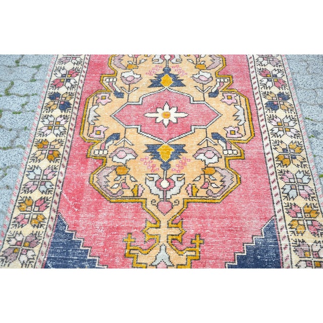 This is a vintage Turkish Oushak rug from the 1960s. The piece was hand-knotted.