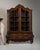 This 19th century Dutch vitrine with brass hardware from Netherlands is built in dark wood as a tall, glazed display...