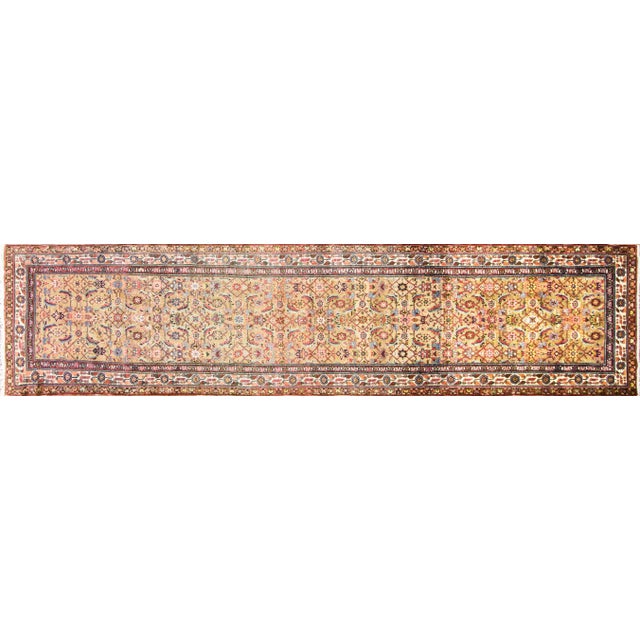 This elegant Antique Persian Malayer runner, woven around 1920, is a superb example of the refined village craftsmanship...