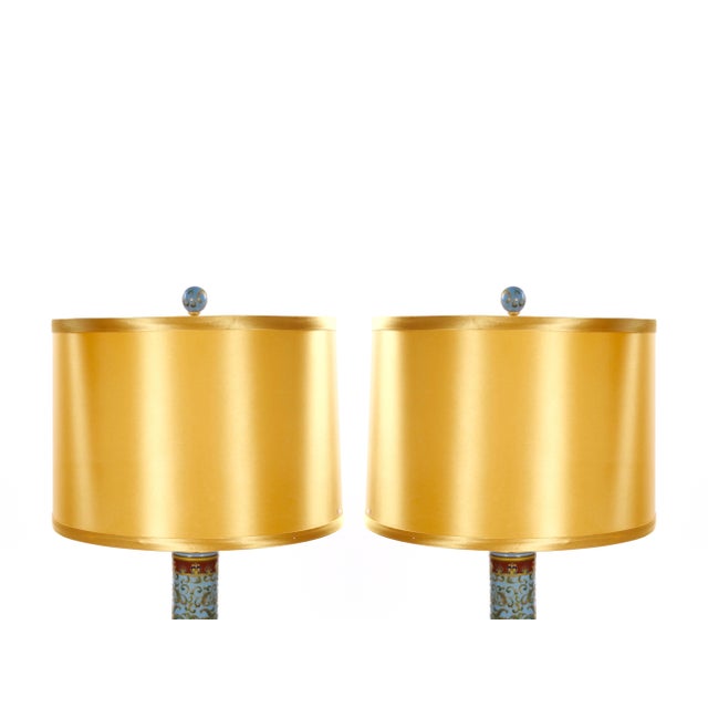 A beautiful pair of Italian porcelain table lamps, crafted in Italy during the late 20th century and showcasing an elegant...