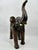 Beautifully aged large leather covered elephant with raised trunk. Glass eyes, standing tall. The tusks are made of molded...