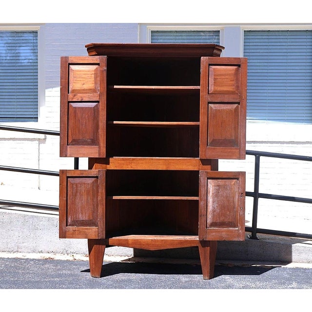 Rising to an impressive 79.2 inches high, the cabinet features a molded cornice above two stacked pairs of doors retaining...
