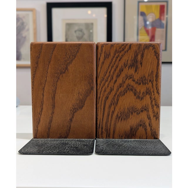 Pair of solid walnut bookends by Marshall Studios featuring flush-set white ceramic inlay. Asymmetrical geometric design...