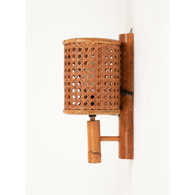 Midcentury amazing sconce "Lantern" wall lamp in rattan and bamboo, in the style of Louis Sognot. Made in Italy in the...