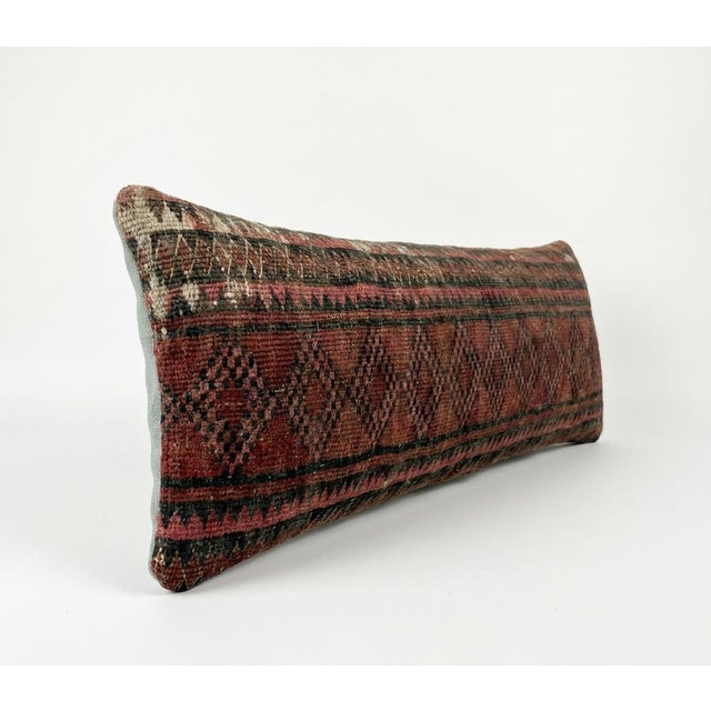 This beautiful 16'' x 47'' pillow cover was made from an authentic Turkish rug. Bright colors of wool adorn the front of...