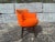 Original 1950s Swivel Arm Chair, orange fabric and black painted wood base. Arm height is 26.50". The chair is not signed.