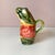 A highly sought after collectible antique French Majolica pitcher crafted in the form of a frog wearing a smoking jacket...