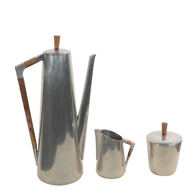 3 piece set of Royal Holland Pewter KMD Daalderop, Tiel. The set includes a tall coffee pot, a covered sugar bowl, and the...