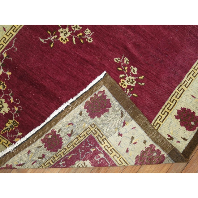 A mid-20th century one of a kind Turkish Anatolian rug with a rare eggplant color background.