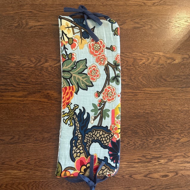 Six long, thin pillows with piping and ties, originally used as decorative crib bolsters. Could be repurposed as tie back...