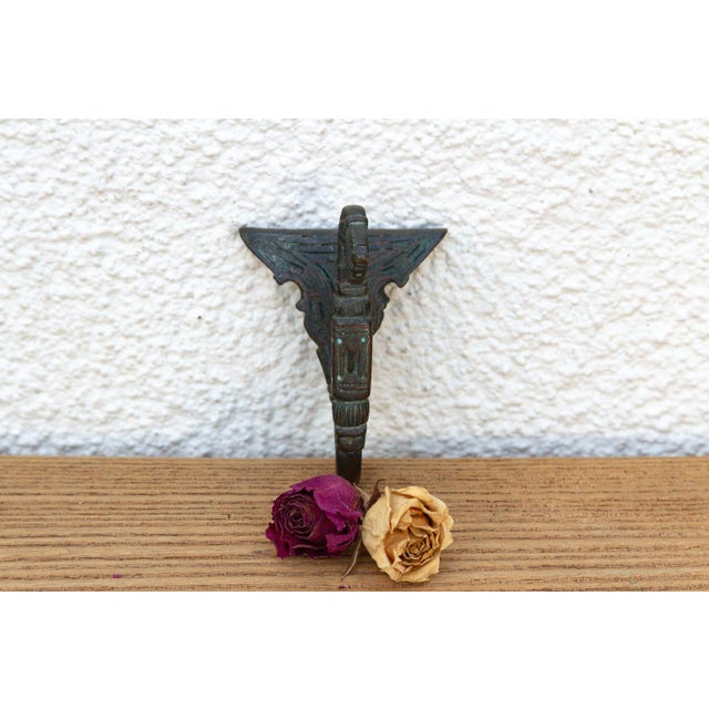 A robust utilitarian antiquity featuring a detailed geometric stem and a stylized architectural bud finial, carrying a...