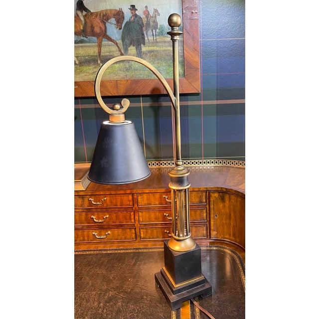Black and Antiqued Gold Painted Metal lamp with metal shade measuring: Total height: 31” Shade base: 6” Shade top: 3”...