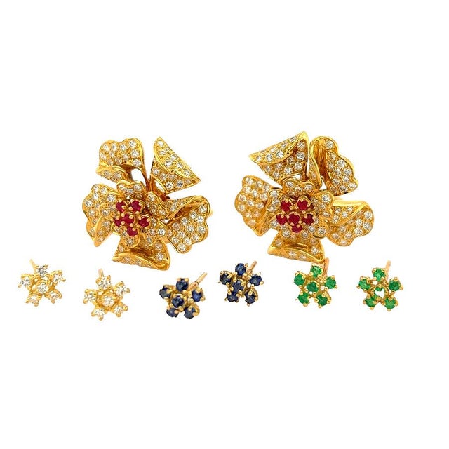 18k Diamond flower earrings with interchangable center in diamond, ruby, sapphire, and emerald inserts. Diamond weight...