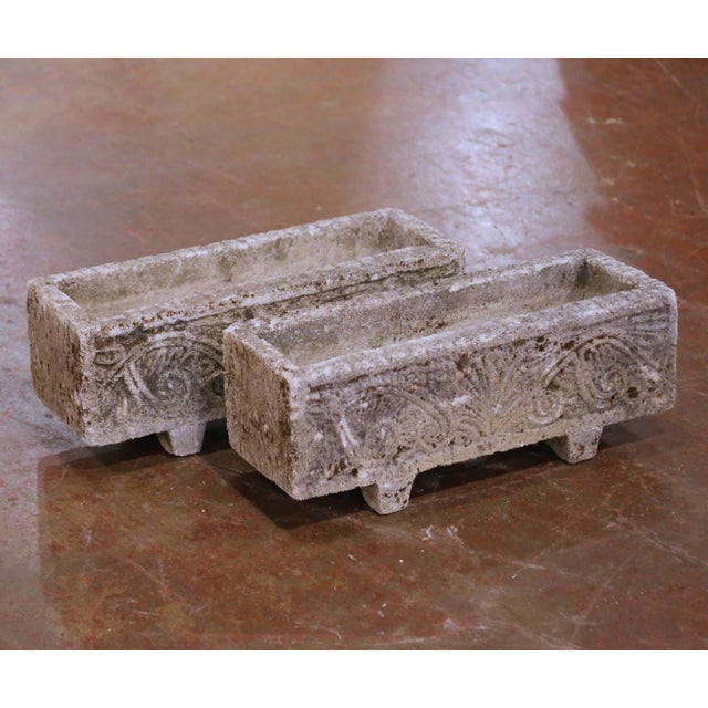 This refined pair of vintage natural stone planters, likely limestone, were crafted in France circa 1920 and reflects a...