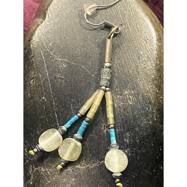 Handmade dangle earrings in the style of the Native American Santo Domingo Pueblo people. The blue coral and heishi beads...