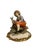 Hand-decorated ceramic figurine depicting a country boy playing with two birds found in a nest. The item is in perfect...