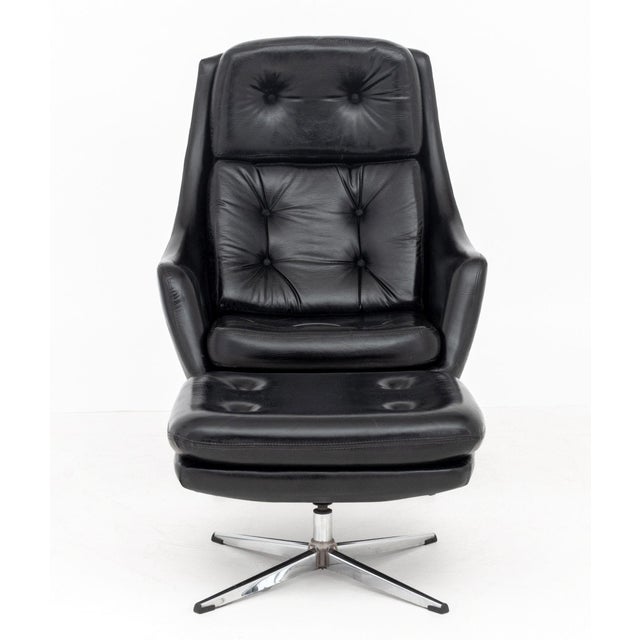 Overman Button-Tufted Black Vinyl Upholstered Swivel Lounge Chair and Ottoman, with silver-tone metal bases, Overman label...