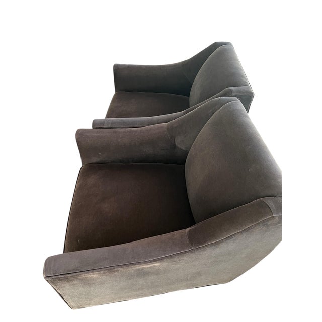 A sculptural shape with sloping arms sits atop a tulip-shaped swivel base on this luxe modern chair from Mitchell Gold and...