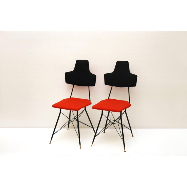 This set of four Italian dining chairs features iron frames with trellis legs and brass ferrule. The chairs have been...