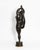 A contemporary figurative bronze of a woman standing on the toes of one foot, her other leg drawn straight up beside her...