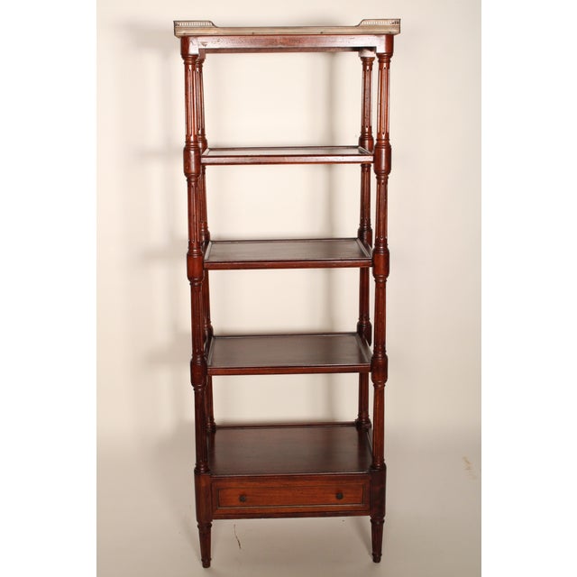Louis XVI style mahogany etagere with a marble top, circa 1930. With a Carrera marble top and a reticulated brass gallery,...