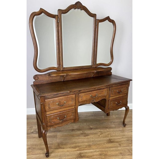 A stunning Vintage French Louis dressing table, beautifully crafted in oak and featuring an elegant triple mirror design...