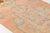 This is a vintage Turkish Oushak rug from the Mid 20th Century. The piece was hand-knotted.
