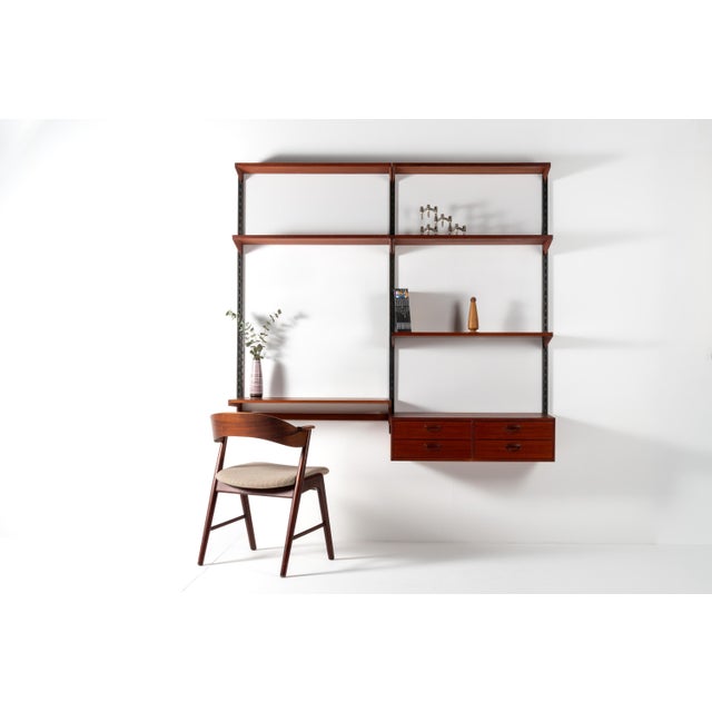 Danish mid-century wall unit made in Denmark in the 1960s. The unit is crafted from teak and consists of wall-mounted...