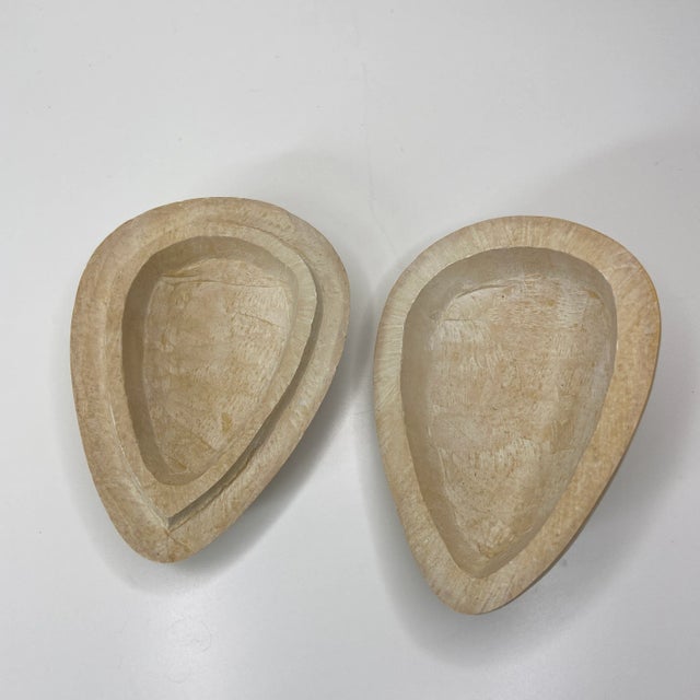 This unique lidded box from Kenya is hand-carved from solid soapstone and features a stylized face design, blending...