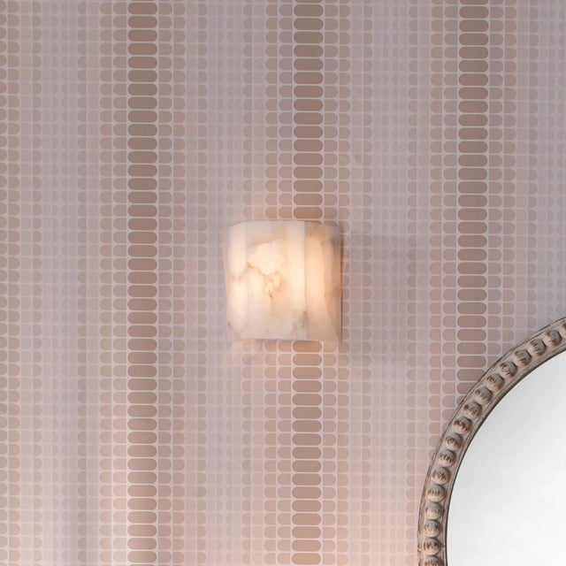 The alabaster Borealis Wall Sconce has the cool luminosity of an Arctic evening. With its organic cut pieces, this hand-...