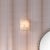 The alabaster Borealis Wall Sconce has the cool luminosity of an Arctic evening. With its organic cut pieces, this hand-...